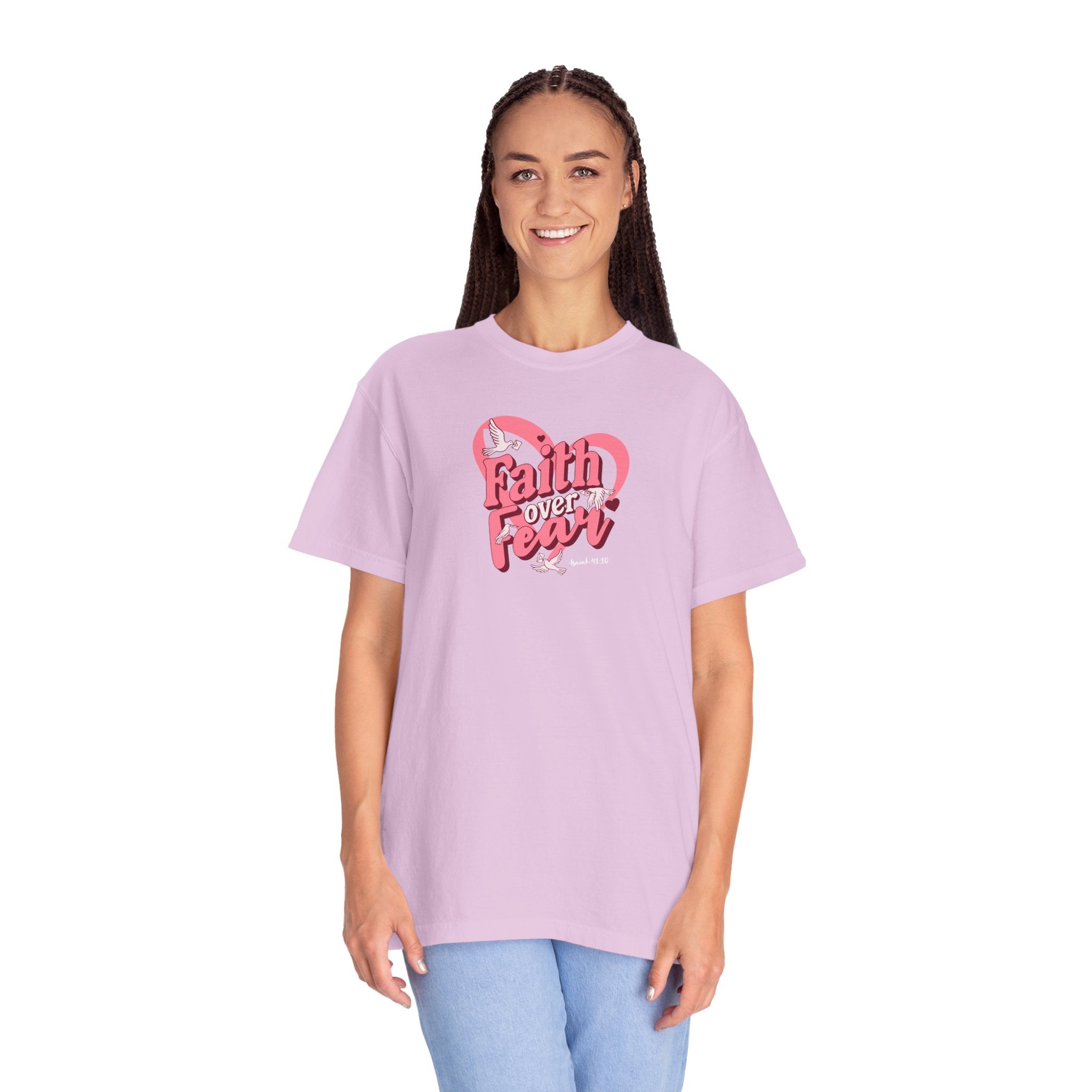 Person wearing a light purple t-shirt with 'Faith Over Fear' text and heart design on a white background