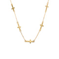 Gold necklace with small crosses on a white background