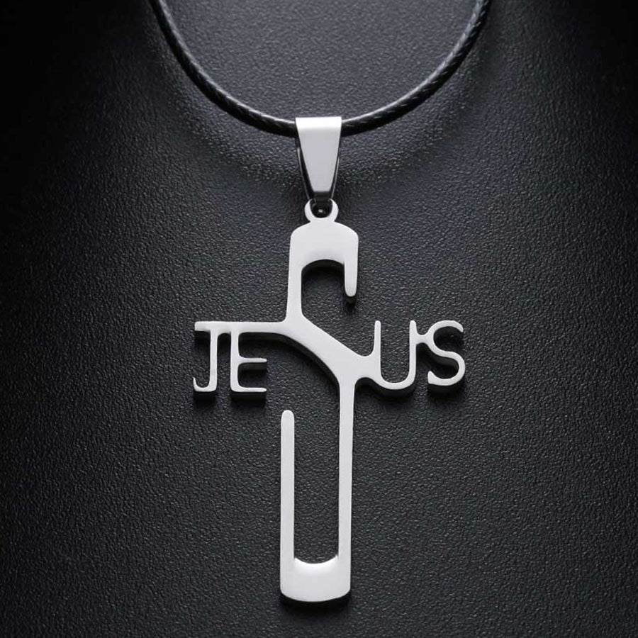 Silver 'Jesus' cross pendant on a black leather strap against a dark background