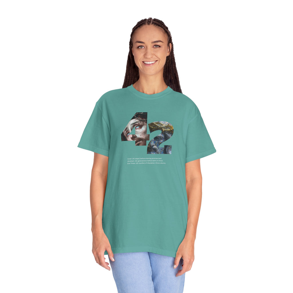 Person wearing a teal t-shirt with a graphic design on a white background