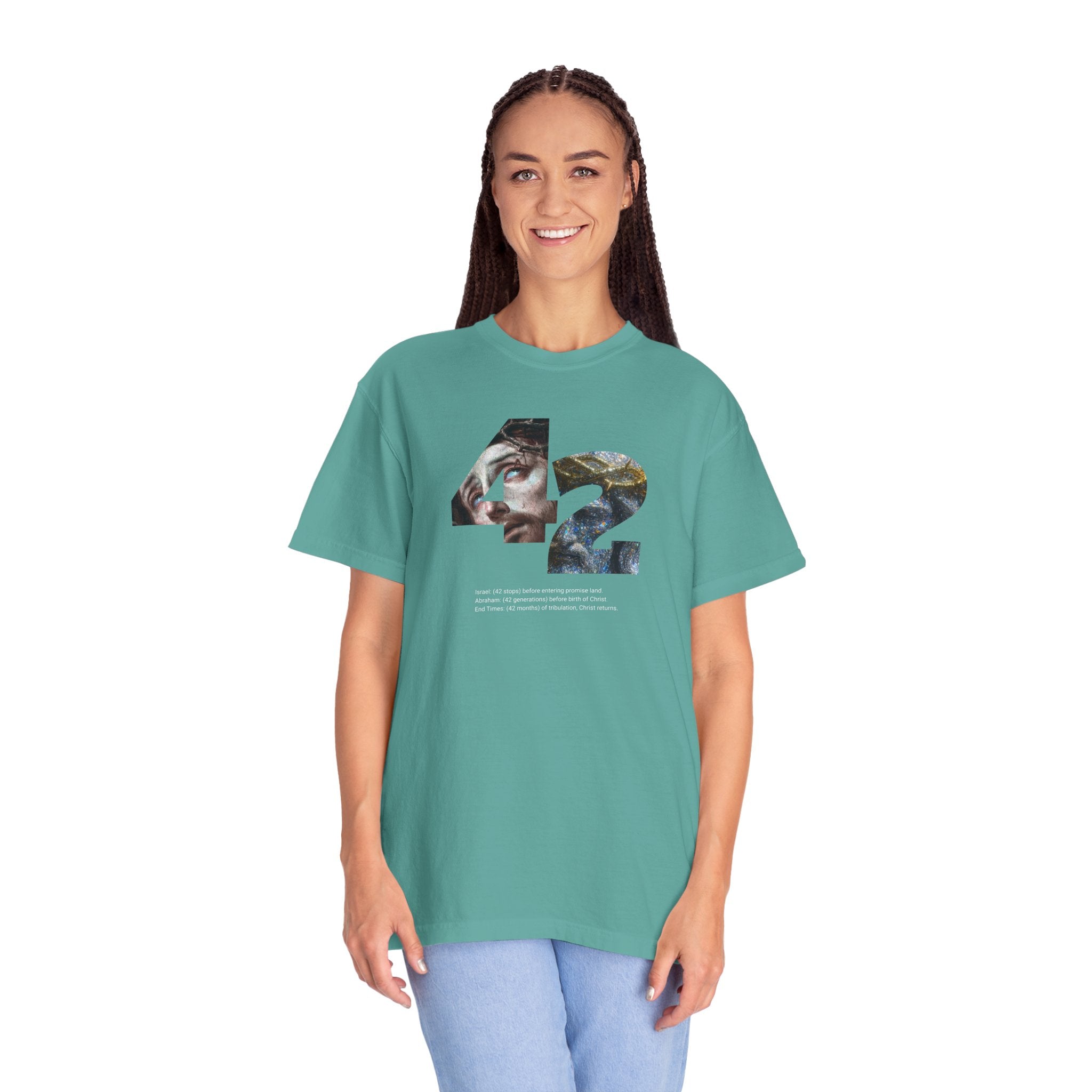 Person wearing a teal t-shirt with a graphic design on a white background