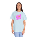 Person wearing a light blue t-shirt with pink text on a white background