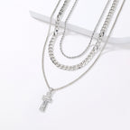Silver necklace with a cross pendant on a white background