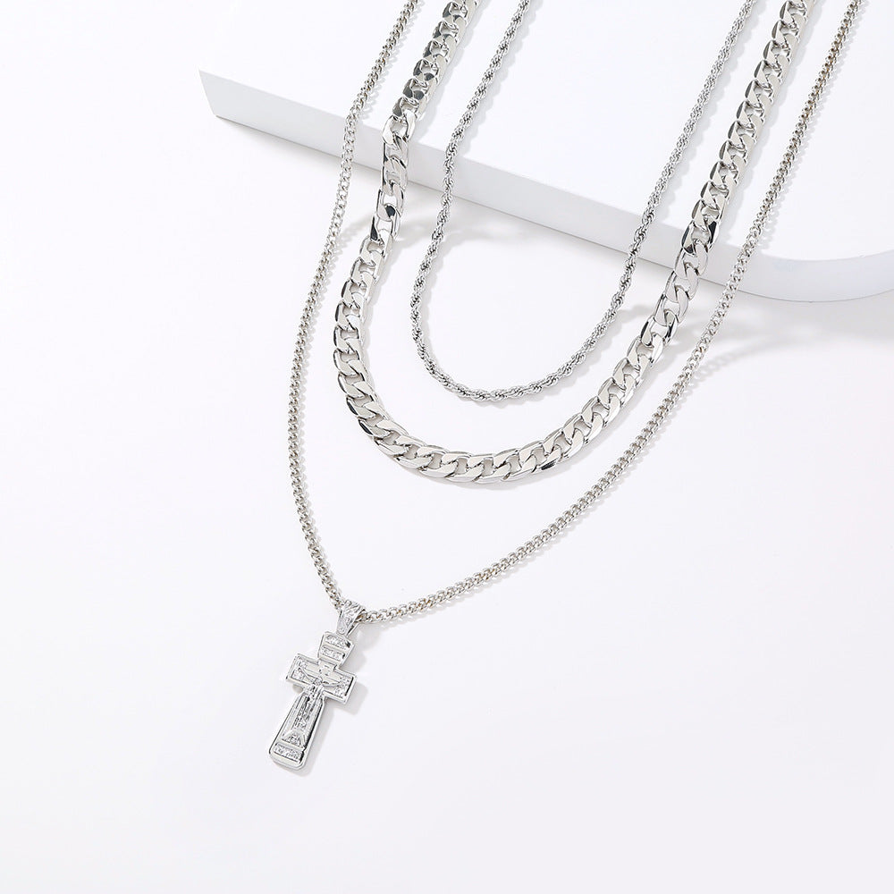 Silver necklace with a cross pendant on a white background