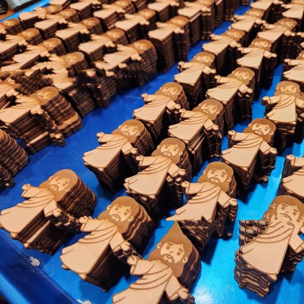 Wooden figurines of a religious figure on a blue surface