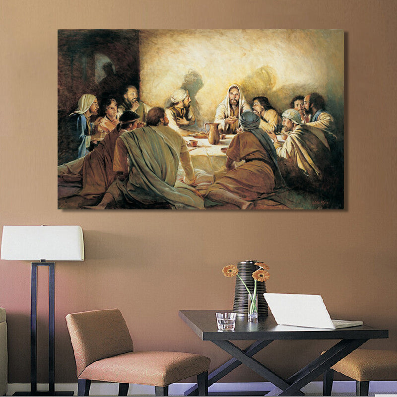 Painting of a religious scene on a wall above a table with a laptop and flowers.