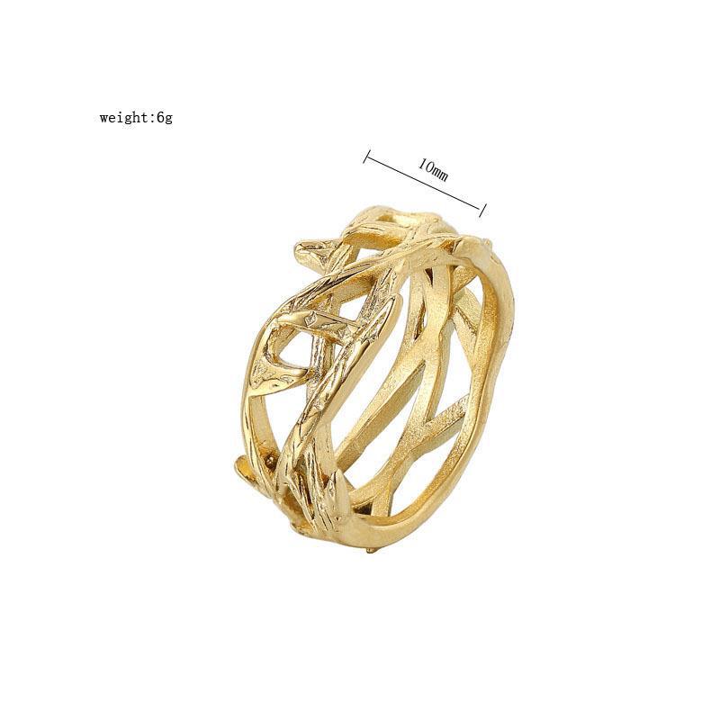 Gold ring with intricate design on a white background