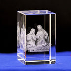 Crystal block with 3D engraved nativity scene on a blue surface