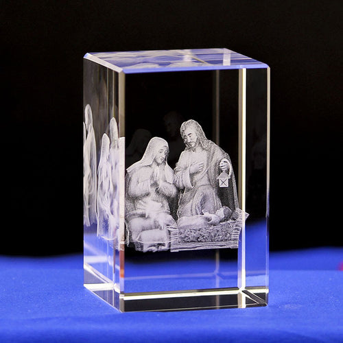 Crystal block with 3D engraved nativity scene on a blue surface