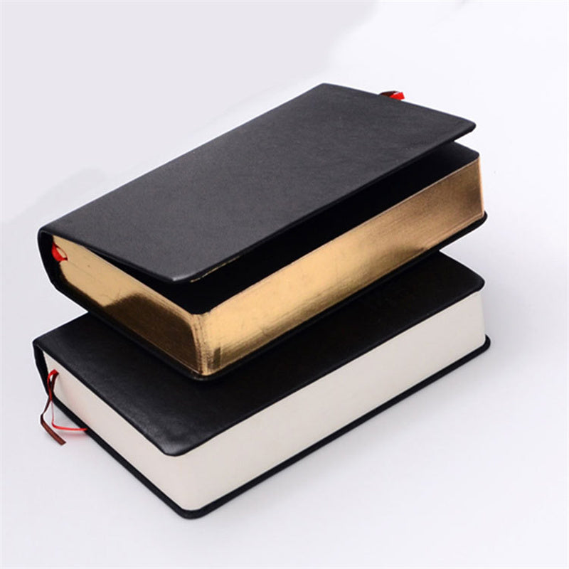 Two black-bound books stacked on a white background