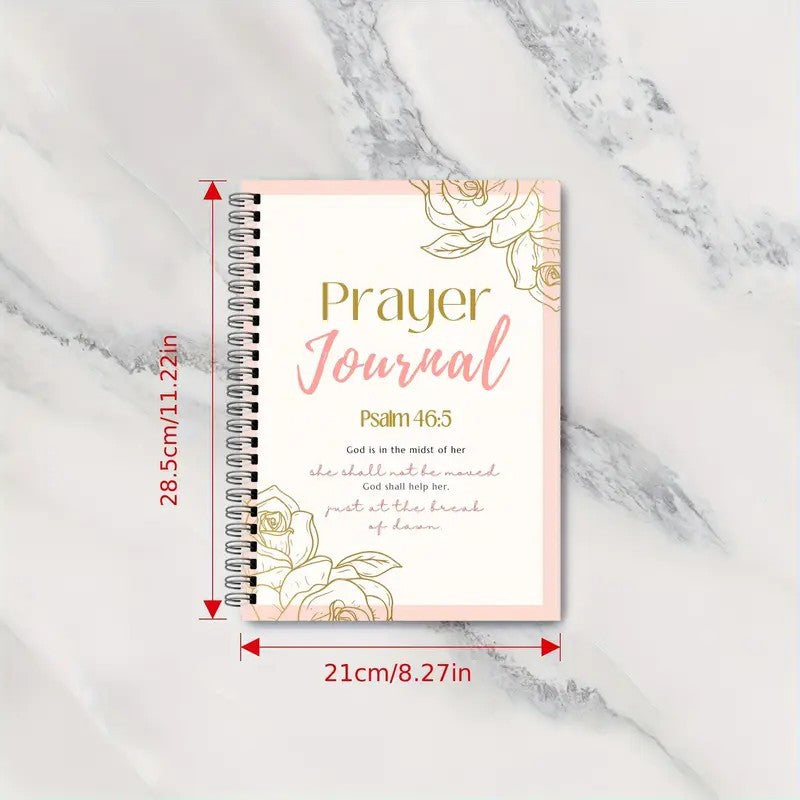 Prayer journal with floral design and measurements on a marble background