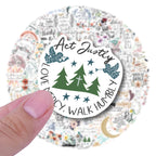 Circular sticker with text 'Act Justly, Love Mercy, Walk Humbly' held by a hand against a floral background.
