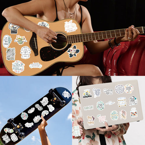 Person playing an acoustic guitar with stickers, skateboard with stickers, and laptop with stickers.