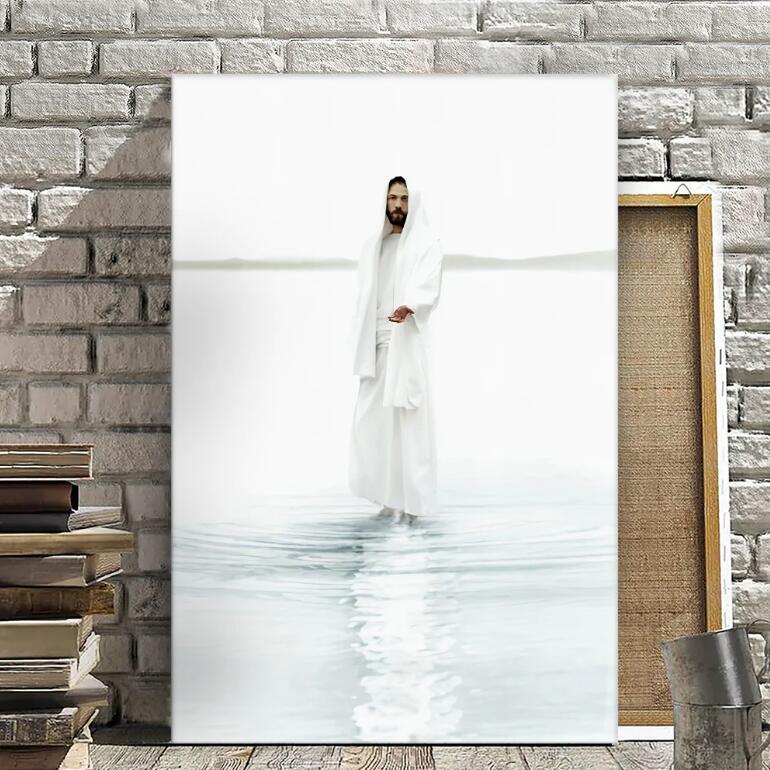 Man in a white robe standing in water with a stone wall and books in the background