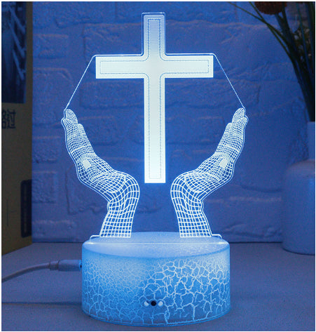 3D LED lamp with hands holding a cross design on a blue background