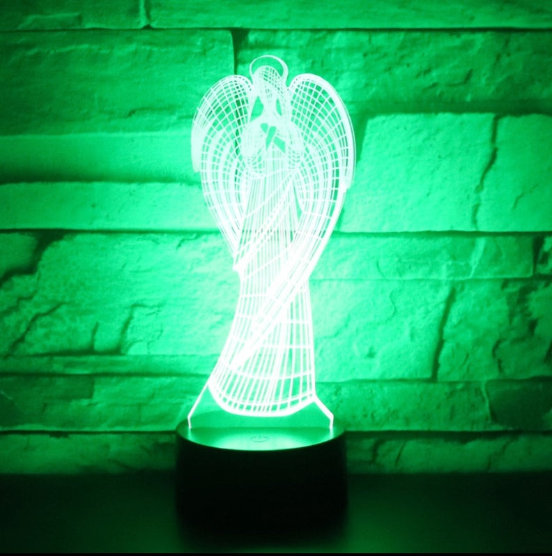 Angel-shaped lamp with green light against a stone wall background