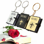 Three Holy Bible keychains with a red rose on an open book