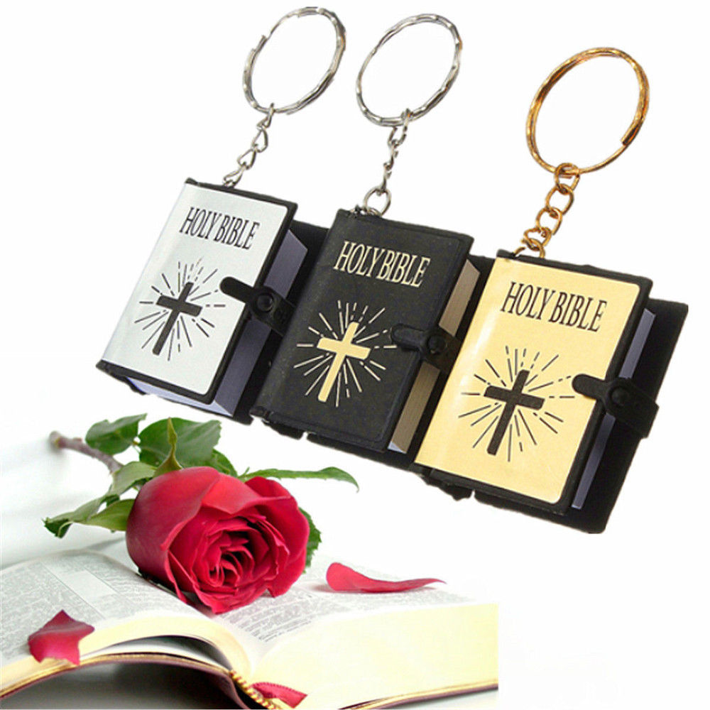 Three Holy Bible keychains with a red rose on an open book