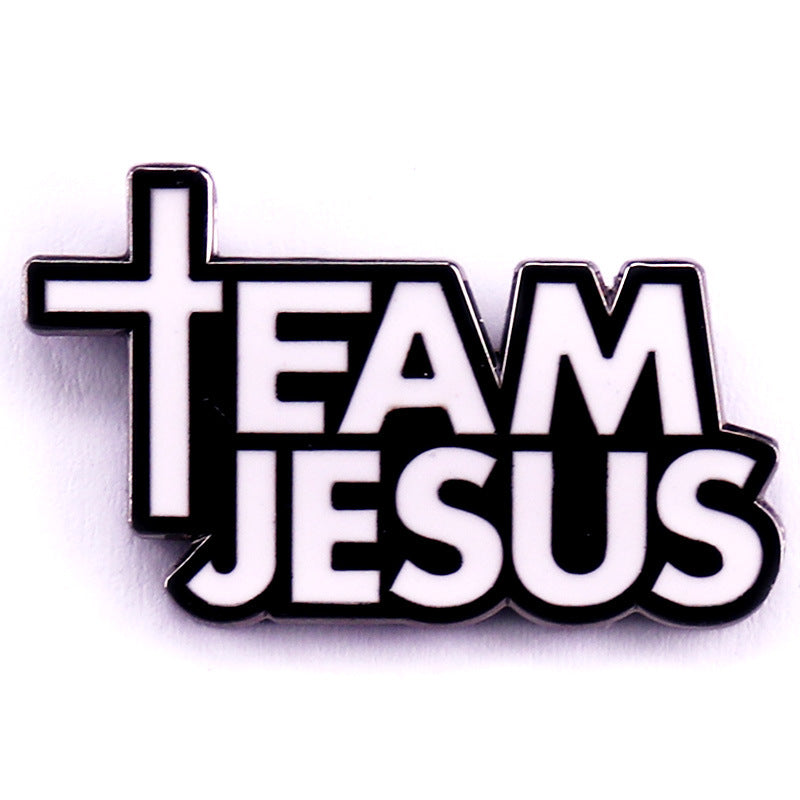 Enamel pin with 'Team Jesus' text and cross design on a white background