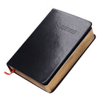 Black leather-bound book with visible brand name on a white background